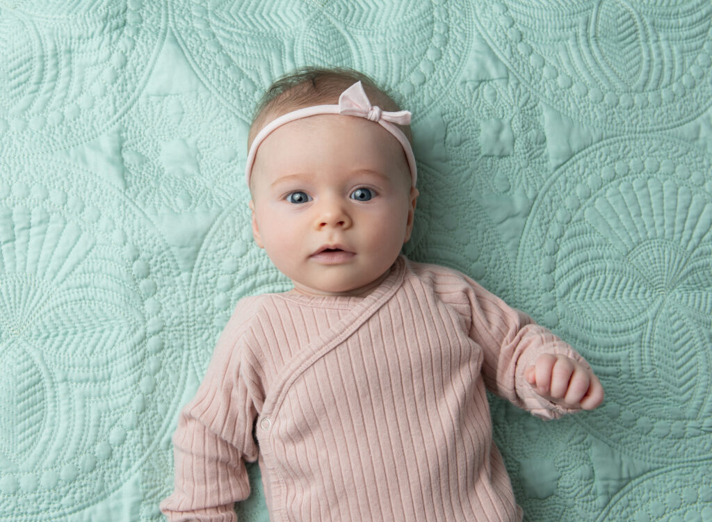 baby milestone portraits of chicago baby in muted pink on mint green blanket