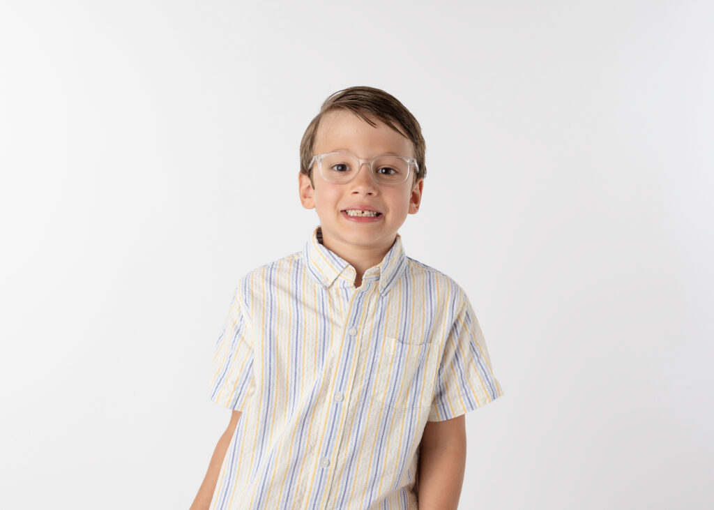 example of what to wear for school  pictures- school aged boy in white shirt and glasses smiling for his school picture