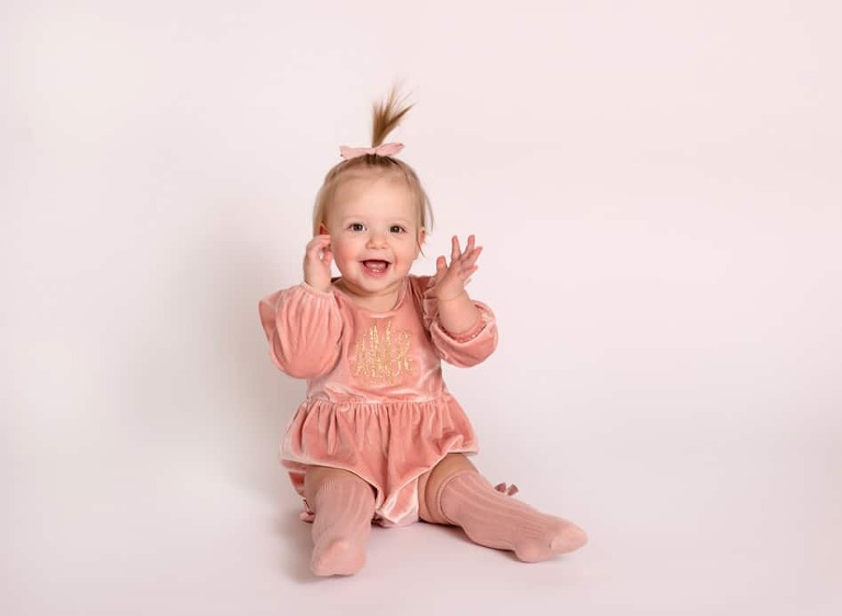 Annie is smiling for her one year photo session in our Lakeview Chicago studio!